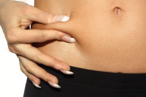 Woman pinching her belly fat
