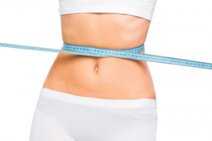 Woman measuring her waist