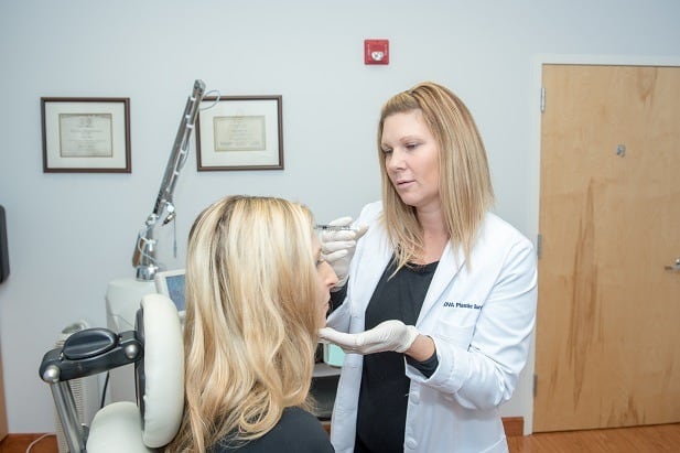 Woman getting a botox injection back angle