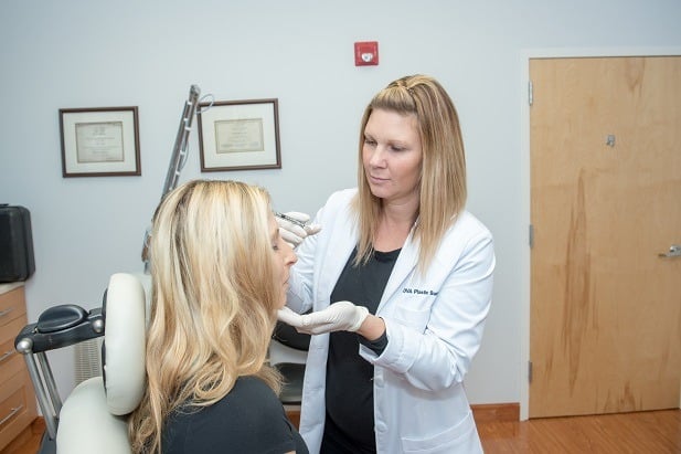 Woman getting a botox injection side angle