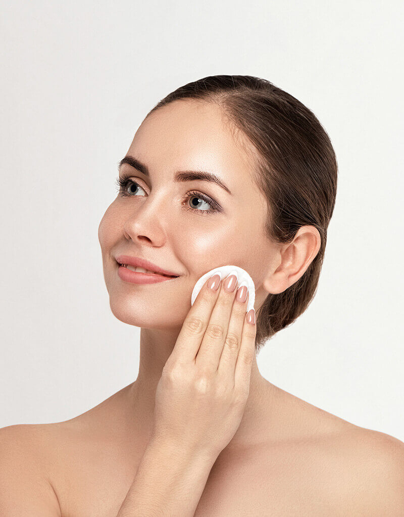 beautiful woman cleaning her face