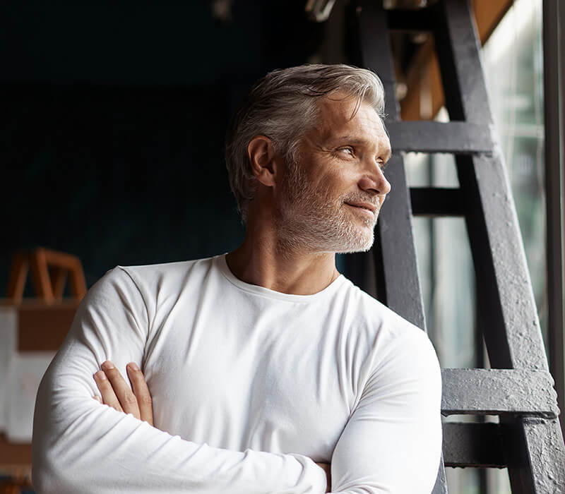 Handsome man looking out window