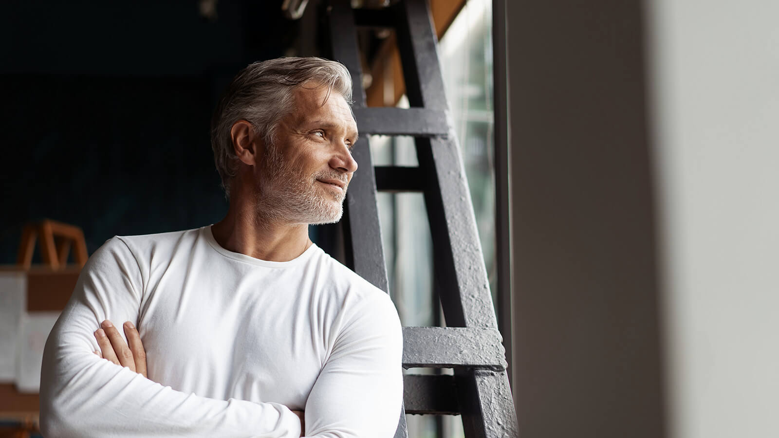 Handsome man looking out of window