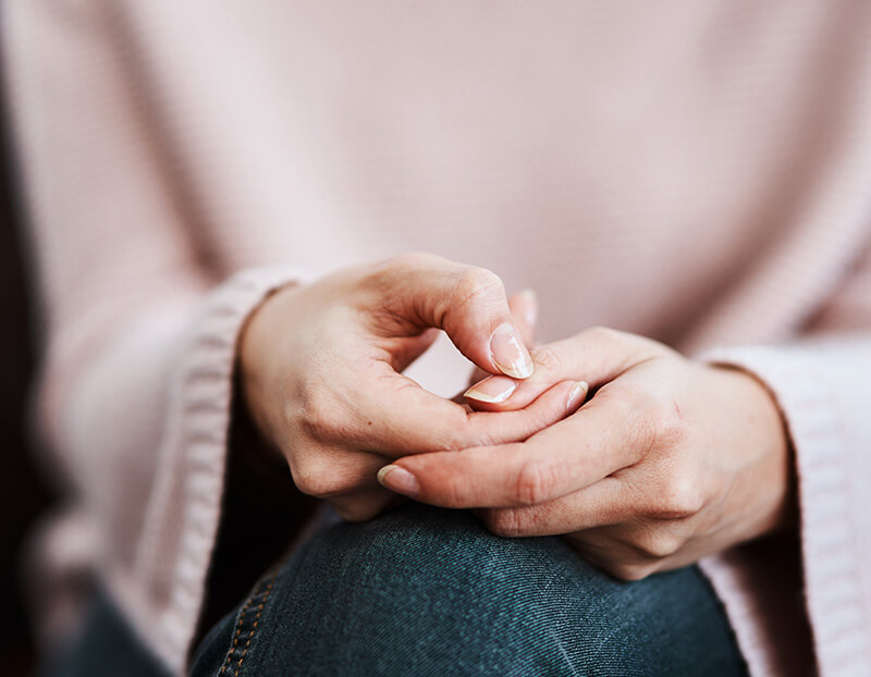 Woman holding her hand