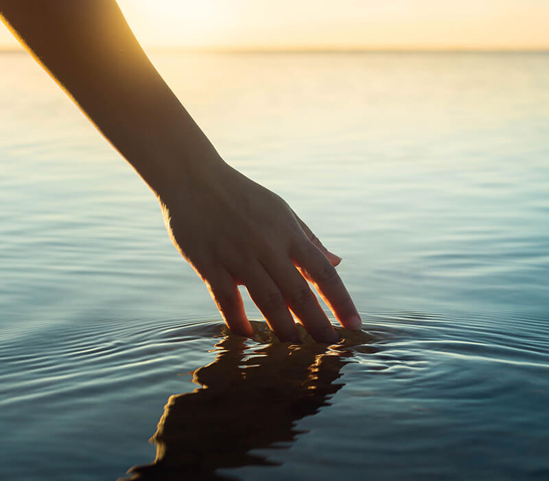 Hand touching water