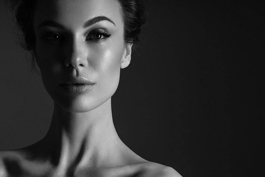 Black and white headshot of a female model