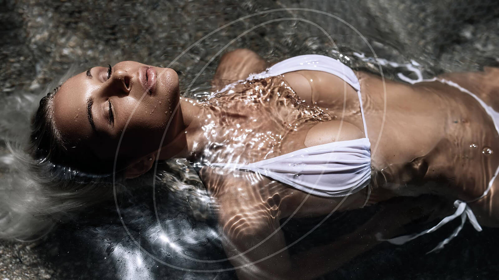 Beautiful woman laying in water