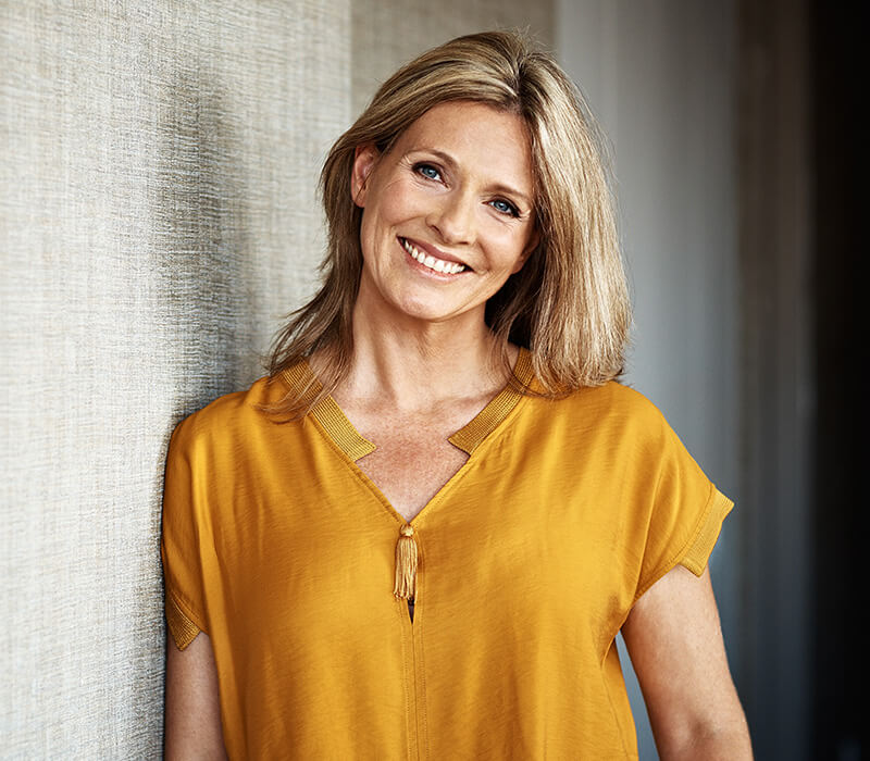 Mature woman in yellow shirt