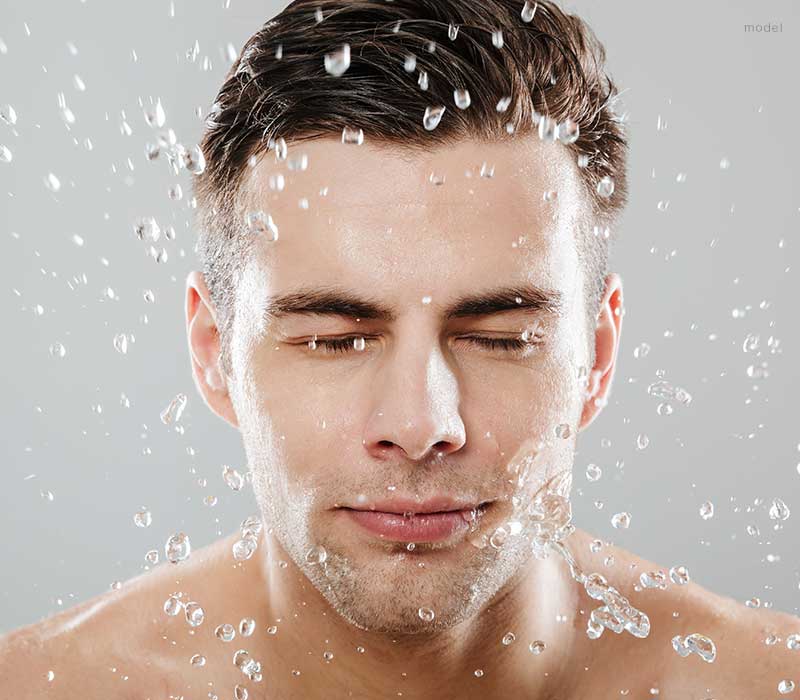 Man splashing water on his face