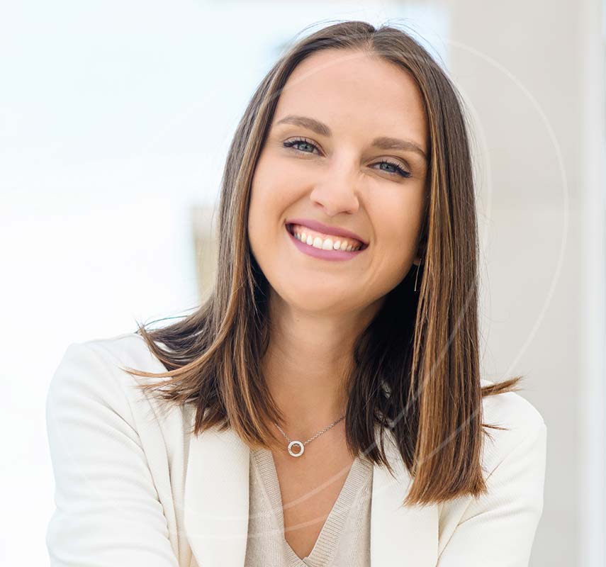 Woman in a cream suit smiling