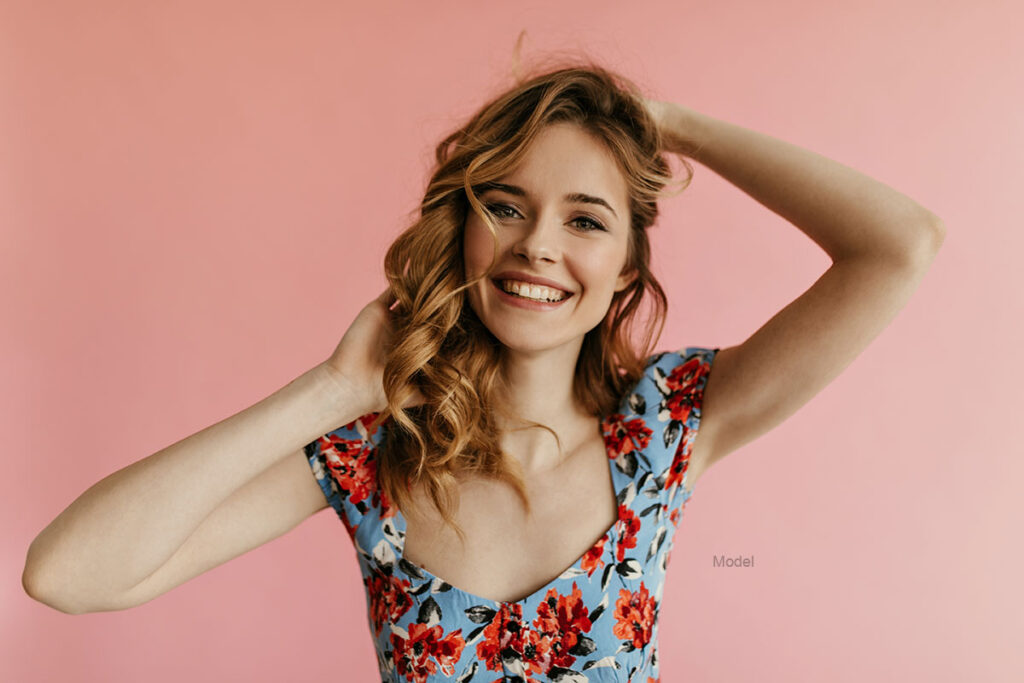 Young woman with curly hair smiling